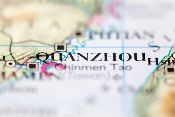Shallow depth of field focus on geographical map location of Quanzhou China Asia continent on atlas