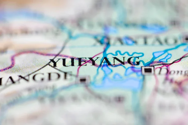 Shallow depth of field focus on geographical map location of Yueyang city China Asia continent on atlas