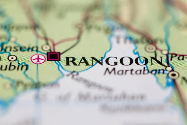 Shallow depth of field focus on geographical map location of Rangoon Yangon city Myanmar Asia continent on atlas