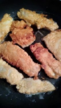 Tilapia balık filetosunu ayçiçeği yağında kızartma tavasında pişirme işlemi.