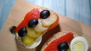 Somon, alabalık, somon balığı, salatalık, yumurta ve zeytinli sandviç.