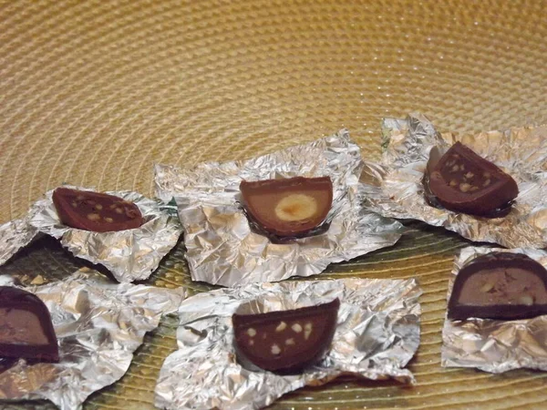 Chocolates embrulhados de prata individuais com diferentes recheios em uma caixa — Fotografia de Stock