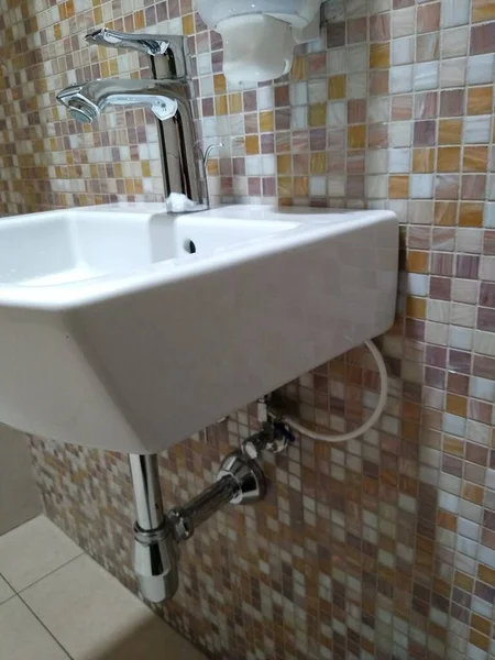 Lavabo de forma cuadrada en un lugar público sobre un fondo beige —  Fotos de Stock