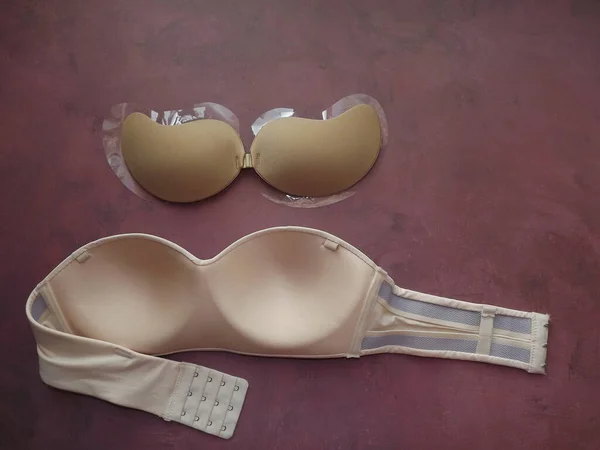 Bras without straps on a burgundy background close-up — Stock Photo, Image
