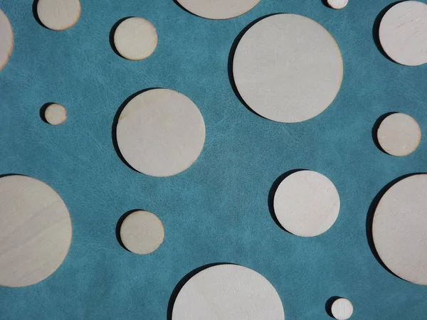 wooden circles of different diameters on blue suede