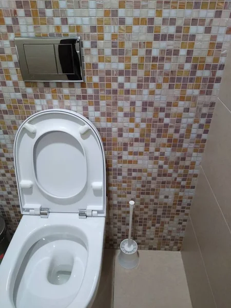 Toilet bowl in the toilet room with beige tiles — Stock Photo, Image