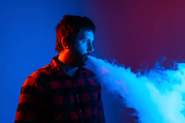 Studio Portrait Colored Lights Young Man Vaping Releasing His Nice — Stock Photo, Image