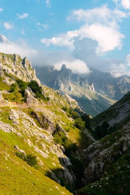 Geçidi boyunca uzanan bir yolu olan görkemli bir dağ manzarası. Picos de Europa Ulusal Parkı, Asturias, İspanya.