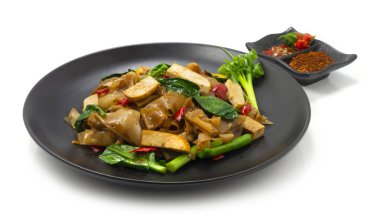 Baharatlı sahanda makarna ve Tofu Vejetaryen Çin usulü dekore edilmiş bahar soğanı biberli yan yemek.