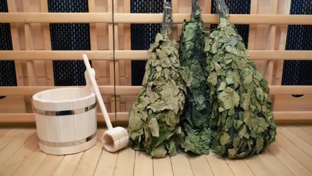 Zoom Out Bunches Of Birch Brooms In Sauna On Wooden Wall — Stock Video