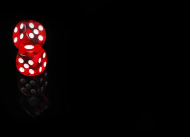 Two red casino dices with  reflection . black background clipart