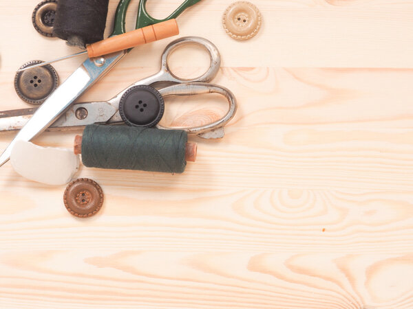 Sewing accessories in a wood background. sewing concept