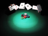 Člověk hraje poker na zeleném pozadí.