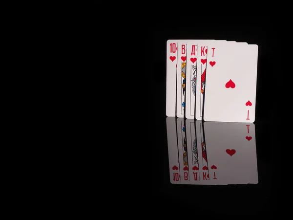 Royal flush playing cards isolated on black background