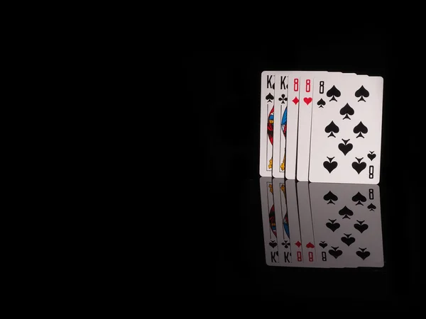 Full House playing cards isolated on black background.