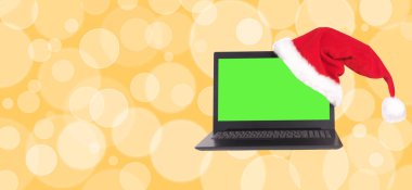 Üzerinde Noel Baba şapkası olan renkli bir defter. Turuncu set..