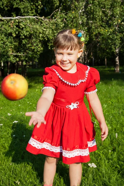 Laughing girl throwing up redapples — Stock Photo, Image