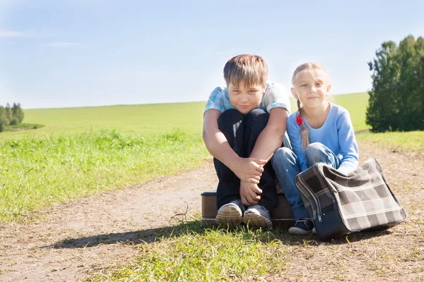 Cute girl and boy with suitcase — Stock Photo, Image