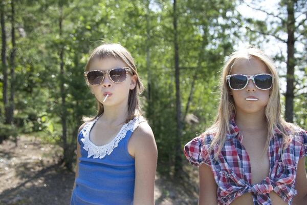 Two pretty  girls with lollipop