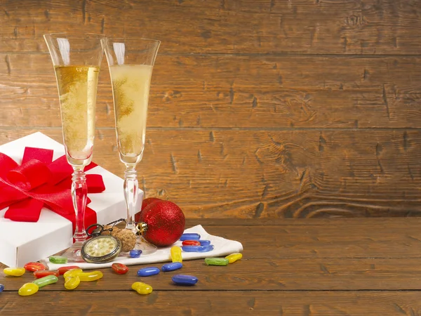 Two celebratory glasses of champagne on a wooden background — Stock Photo, Image