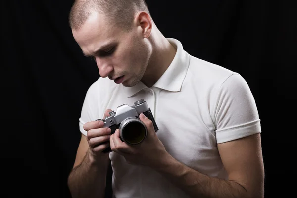 Un giovane fotografo esamina la vecchia macchina fotografica — Foto Stock