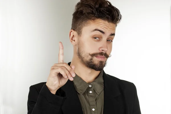 man narrowed his eyes and raised his index finger