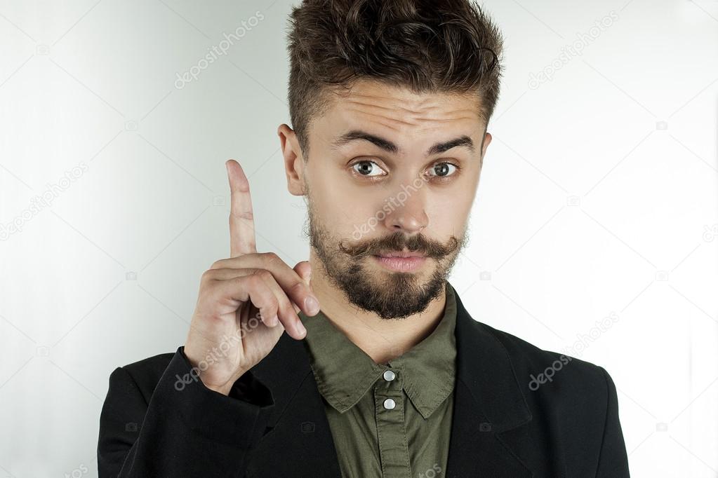 man in stylish clothes held up an index finger