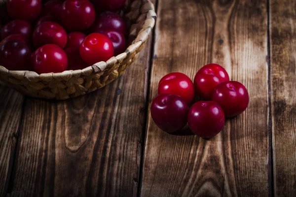Plums on wooden background — Stock Photo, Image