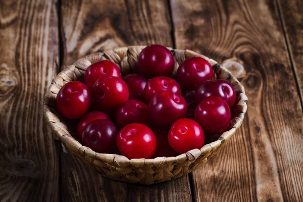 Plums on wooden background — Stock Photo, Image