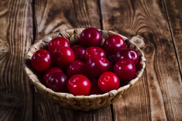 Plums on wooden background — Stock Photo, Image