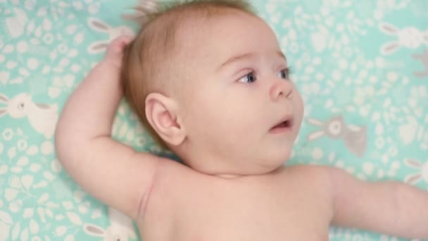 Close Portrait Caucasian New Born Baby Laying Soft Blanket Serious — Stock Video