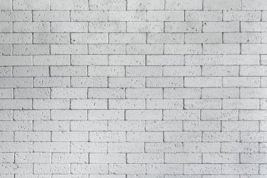 Çatı katı tarzı beyaz tuğla duvar. Arka plan olarak kullanılmak üzere taş duvar gri tonlarından oluşan yüzeysel beyaz bir duvar. Tuğla oda, iç döşeme, duvar arka planı. Beyazlatılmış duvarcılık dokusu