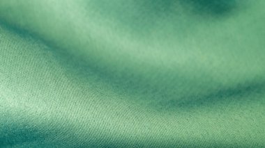 Su renginde güzel dalgalı ipek kumaş. Pürüzsüz, lüks kumaş dokusu. Soyut yeşil arkaplan tasarımı. Boşluğu kopyala