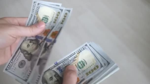 Close up of hands counting a pack of 100 dollar bills or paying in cash. Payment procedure. Show off, pay bills or give bribe. Concept of investment, success, financial prospects — ストック動画