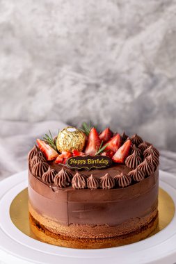 Chocolate cake decorated with strawberry  for birthday cake on white stand cake.