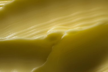 Süper makro dalgalı margarin deseni. Yaygın bir mutfak malzemesi tereyağına daha sağlıklı bir alternatif olarak gösterilir. Yayılabilir ve sarı renk