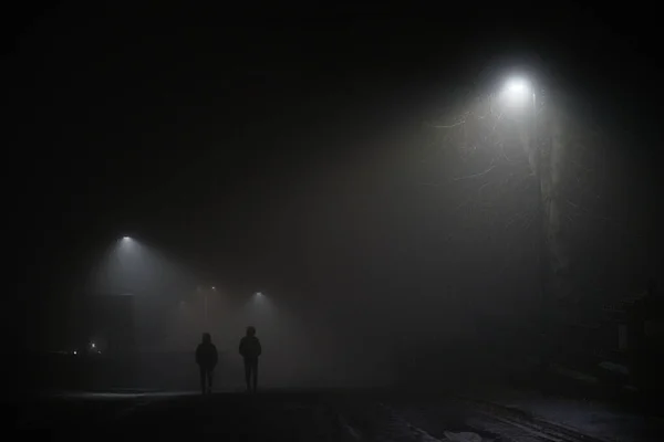 Two Mysterious Hooded Men Walk Away Dark Foggy Road Lit — Stock Photo, Image