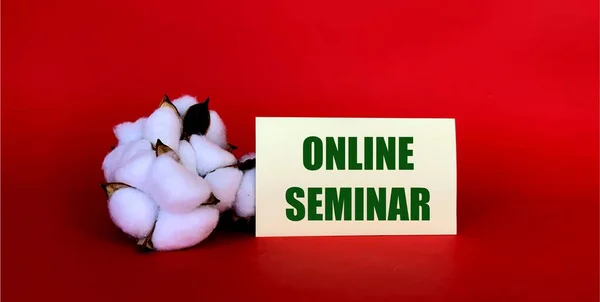 Online seminar on yellow paper on a red background.