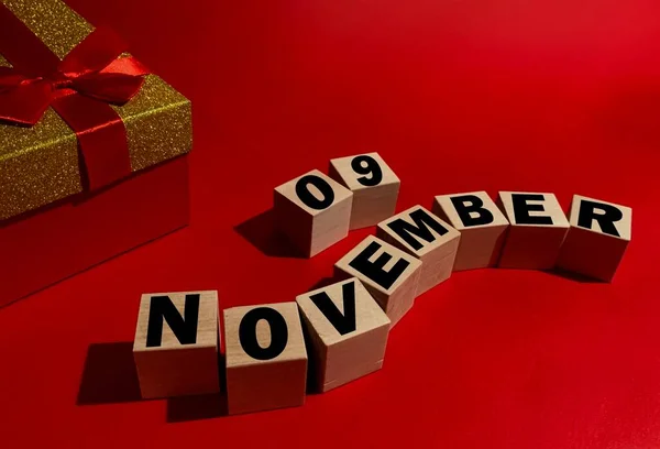 11月9日在木制立方体上 红色礼品盒在红色背景上 — 图库照片