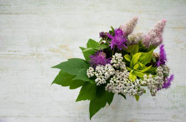 Ahşap bir arka planda bir buket yabani çiçek. Kırsal tarzda. Boşluğu kopyala.