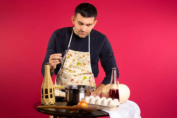Cozinheiro Masculino Segurando Uma Tampa Olha Para Uma Panela Foto — Fotografia de Stock