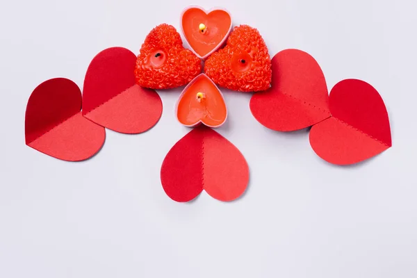 Valentines Day. Gray background with red paper hearts and red scented candles. — Stock Photo, Image