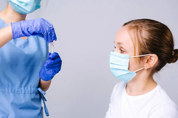 En patient i medicinsk mask och en läkare med kolv - test för covid 19. Grå bakgrund. Beskuren bild — Stockfoto