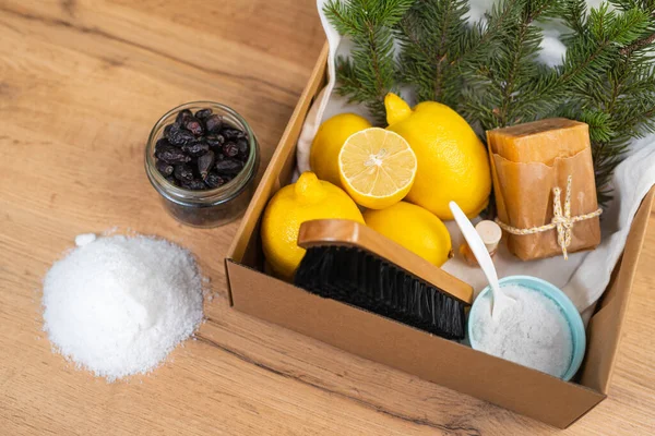 Eco-friendly and household cleaning tools, baking soda, salt, bamboo brush and luffa sponge on the kitchen table. High quality photo