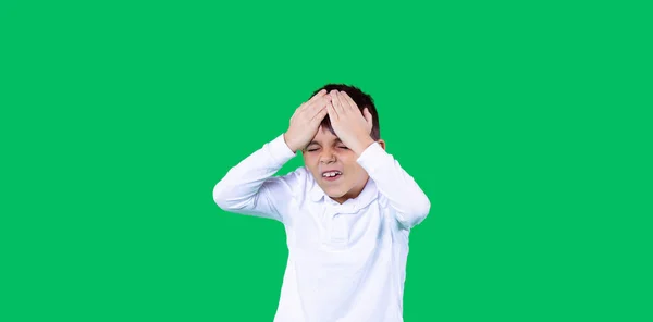 Banner, long format. Green background. A boy is holding a head. He is unhappy and upset. — Stock Photo, Image