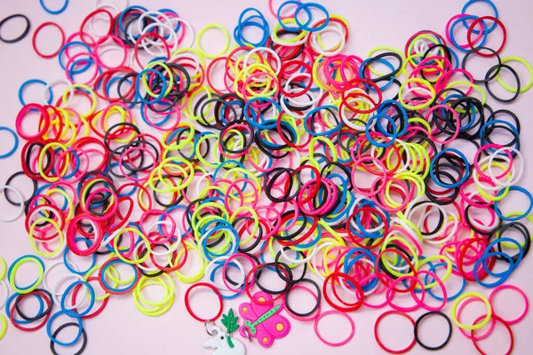 Abstract background with circles. Colored rubber bands for weaving bracelets, toys.