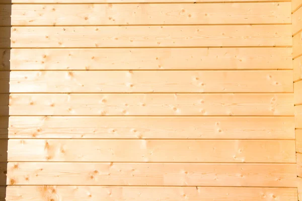 wooden wall background. Wooden construction glued laminated timber in the wall of the house.