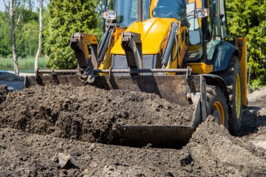 Tekerlek yükleyici çalışıyor. Toprak yükleme kovasında. Kova Yükleyici Dünya TaşımacıComment.
