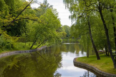 Landscape with the image of a river in the city park.