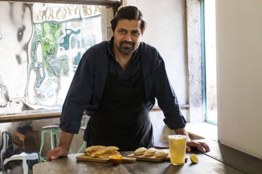 Lizbon 'da küçük bir restoranda yeni yemekler yapan büyüleyici bir aşçı. Neşeli restoran sahibi, öğle yemeğinde yeni Empanada tabaklarını ve Portekiz Bifana tabağını kendi kafesinde gösteriyor.
